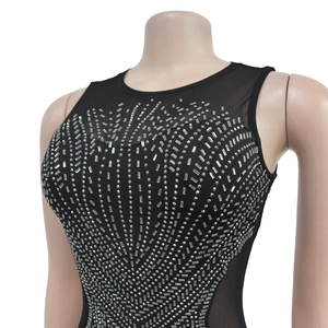Detail of black sleeveless dress with mesh stitching and radiating silver rhinestones