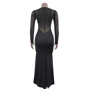 Detail view of the back of a black bodycon dress featuring gold and silver rhinestones