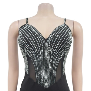 Detailed view of black V-neck dress with silver rhinestones and mesh side panels