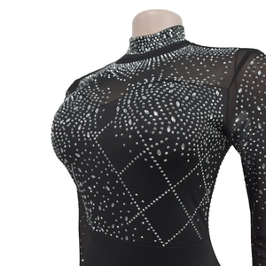Detailed macro view of silver rhinestones and sheer mesh on black long sleeve dress