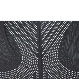 Detail of black mesh fabric with symmetrical silver rhinestones on a sleeveless dress