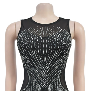 Detail of black sleeveless dress with silver rhinestones and mesh patchwork at neckline