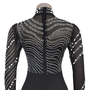 Detail of sheer black mesh back with white pearls and rhinestones on long sleeve bodysuit