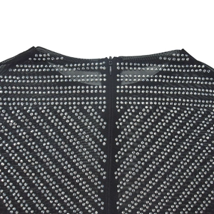 Detailed view of sheer black mesh dress with sparkly rhinestones and hidden zipper