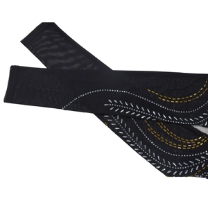 Detail of sheer black mesh sleeves featuring wave pattern silver and gold rhinestones