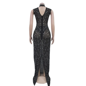 Detail view of back split hem and silver rhinestone patterns on sheer black mesh dress