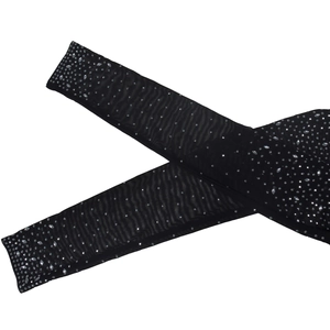Detail of sheer black mesh sleeves with sparkling silver rhinestones on a white background