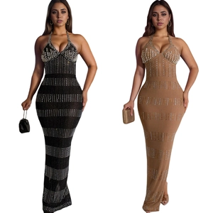 Detail of lace maxi dress with rhinestones and pearl embellishments in black and camel