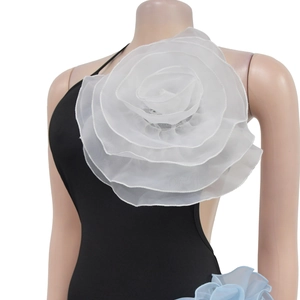 Detail shot of the 3D organza white floral decoration on black solid color dress