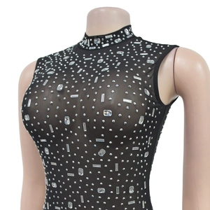 Detailed view of black mesh sleeveless top with dense sparkling rhinestones and high collar
