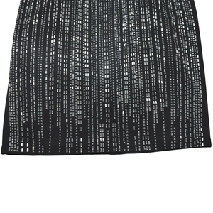 Detail of black dress hem with silver sequins and beads in heavy beadwork pattern