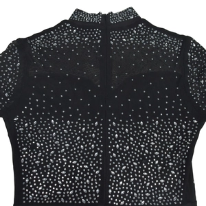 Detail of black mesh dress featuring shimmering rhinestones and a hidden back zipper