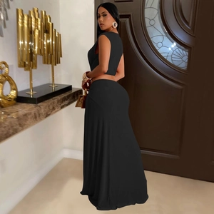 Detail of elegant two-piece black set featuring sleeveless crop top and high-waisted skirt