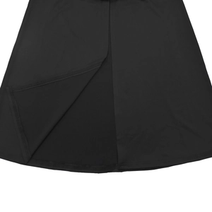 Detail view of overlapping slit design on a black dress with smooth fabric and clean stitching