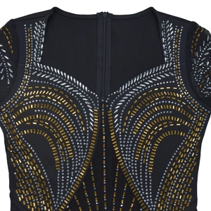 Detail of sweetheart neckline dress with intricate gold sequins and mesh sleeves