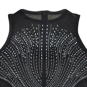 Close-up of black sleeveless dress featuring mesh neckline and sparkling rhinestone patterns