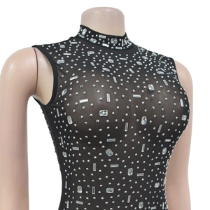 Close-up of black mesh sleeveless top with shimmering silver rhinestones and high neck