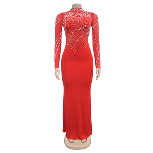 Detail of red floor-length evening dress with shimmering pearls and silver sequin waves