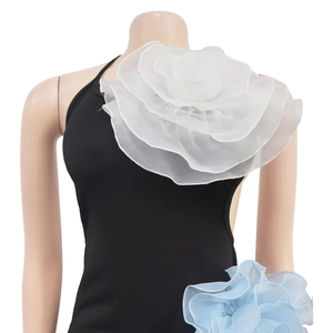 Detail of elegant black halter top with oversized white 3D organza flower on shoulder