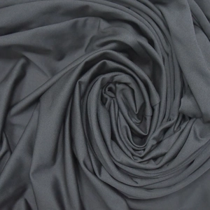 Macro shot showing the texture of dark grey elastic knitted fabric with soft luster