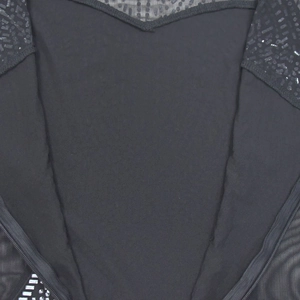 Detail of black dress neckline featuring sheer mesh panel and sequin beaded accents