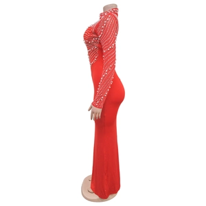 Detail of red slim fit maxi dress featuring intricate white pearls and sequin embellishments