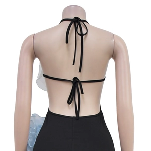Detail of backless halter dress with black fabric and light blue organza ruffles