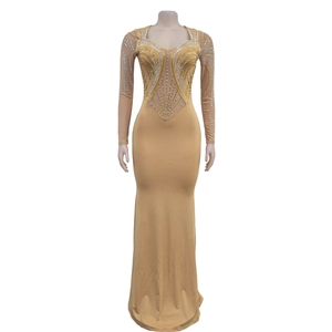 Detailed view of nude evening gown featuring symmetrical hot-fix rhinestones and mesh sleeves