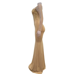 Detail of champagne evening dress with gold rhinestones and fish-tail mesh design