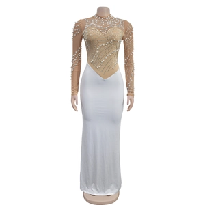 Detail of evening gown featuring pearl and rhinestone embellishments on mesh sleeves