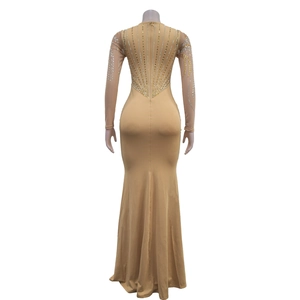 Detail view of the back showing intricate gold and silver rhinestones on a nude maxi dress