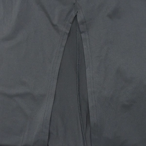 Detailed view of side split hem with double stitching on black elegant long dress