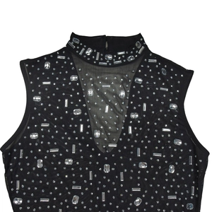 Detail of black mesh sleeveless top with shimmering rhinestones and high neck design