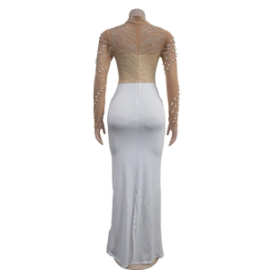 Macro detail of the sheer mesh back with silver rhinestones and white pearls on a maxi dress