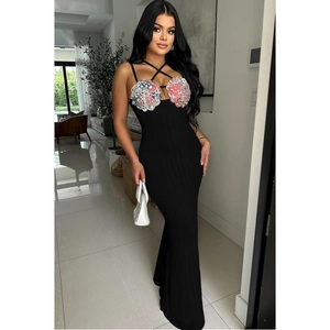 Close-up of elegant floral embroidery on a black sleeveless halter maxi dress