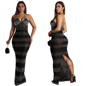 Detail of black halter maxi dress showing deep V-neckline and sparkling rhinestone patterns
