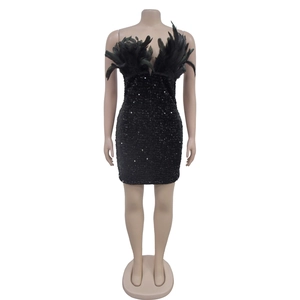 Detail of black sequined mini dress featuring decorative feather trim at the neckline