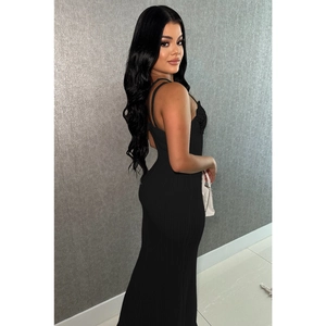 Close-up of black sleeveless maxi dress with thin straps and textured vertical fabric