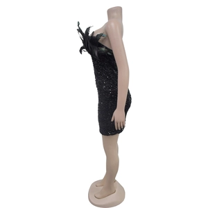 Detail view of black sequin mini dress featuring feathered neckline and sleeveless design