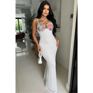 Detail view of white knitted mermaid dress with colorful floral sequin embroidery decor