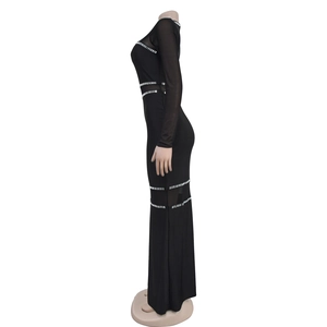 Detailed side view of mesh panels and silver rhinestone trim on a black long-sleeve dress