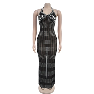 Detail of sheer black mesh dress featuring intricate white pearls and sparkling rhinestones