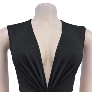 Close-up of black deep V-neck sleeveless top with elegant pleated detail and textured fabric