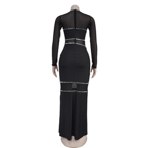 Detail view of the rhinestones and mesh patchwork on back of black maxi dress