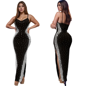 Detail of a slim-fit black dress with white sequins, V-neck, thin straps and high side slit