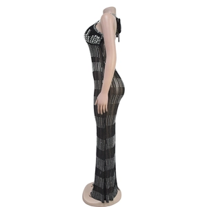 Detail of elegant black evening dress showing white pearls and rhinestones on lace