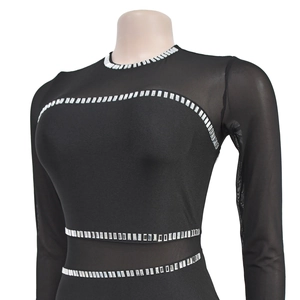 Detailed view of black rhinestone mesh dress showing sparkling silver crystal embellishments