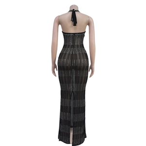 Back view of black halter neck mesh dress with silver rhinestones and slit