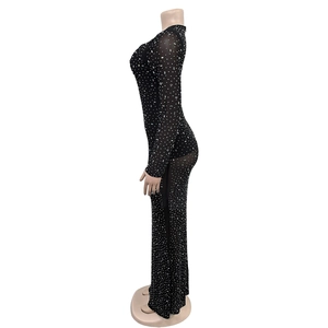 Close-up of black mesh maxi dress featuring intricate silver rhinestone detailing
