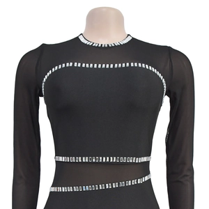 Detail of sheer mesh patchwork on black bodysuit with sparkling silver rhinestones
